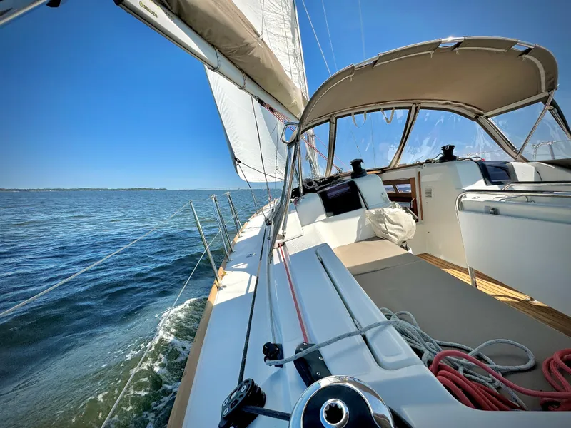 Slide: The Image of 2015 Jeanneau Sun Odyssey 379 sailing on open water under clear blue skies. - 11