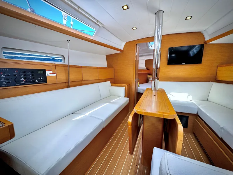 Slide: The Image of Interior of 2015 Jeanneau Sun Odyssey 379 sailboat with modern wood finish and white seating. - 3