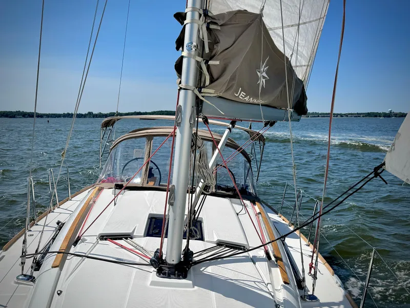 Slide: The Image of 2015 Jeanneau Sun Odyssey 379 sailing on open water, clear sky. - 10