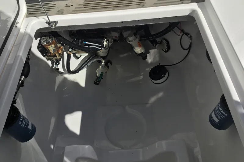 Slide: The Image of 2025 Sportsman Open 322 Center Console boat interior with visible wiring and components. - 53