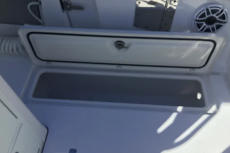 Slide: The Image of Open storage compartment on 2025 Sportsman Open 322 Center Console boat. - 55