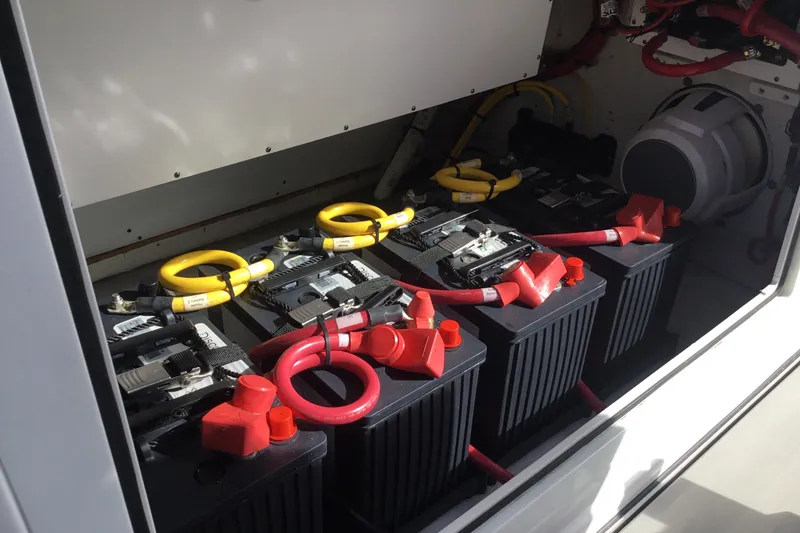 Slide: The Image of Battery compartment of 2025 Sportsman Open 322 Center Console boat, featuring multiple batteries and cables. - 45