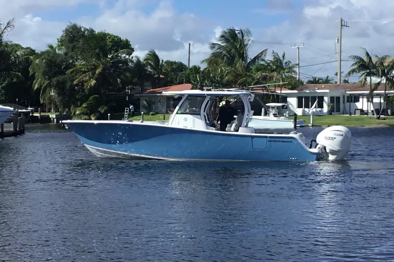 Slide: The Image of 2025 Sportsman Open 322 Center Console boat cruising on a sunny day. - 10