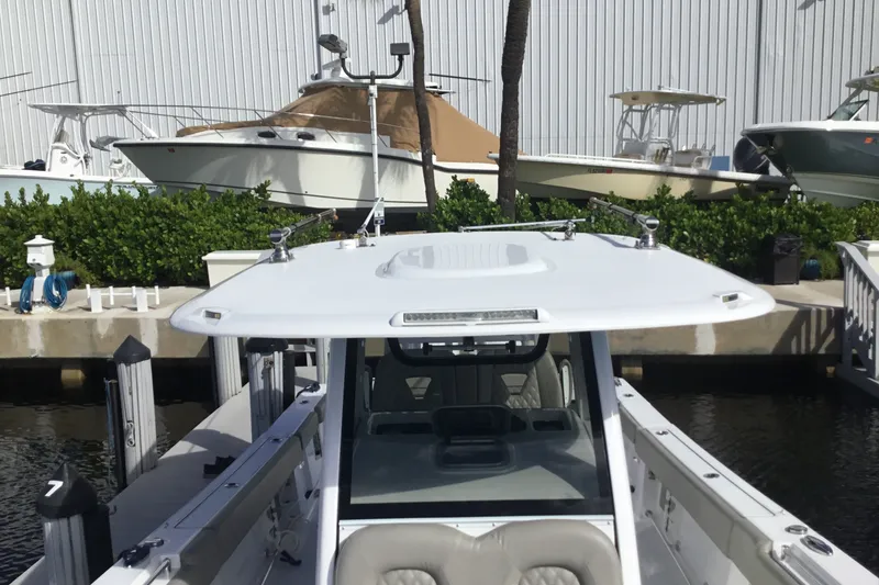 Slide: The Image of 2025 Sportsman Open 322 Center Console boat docked at marina. - 17