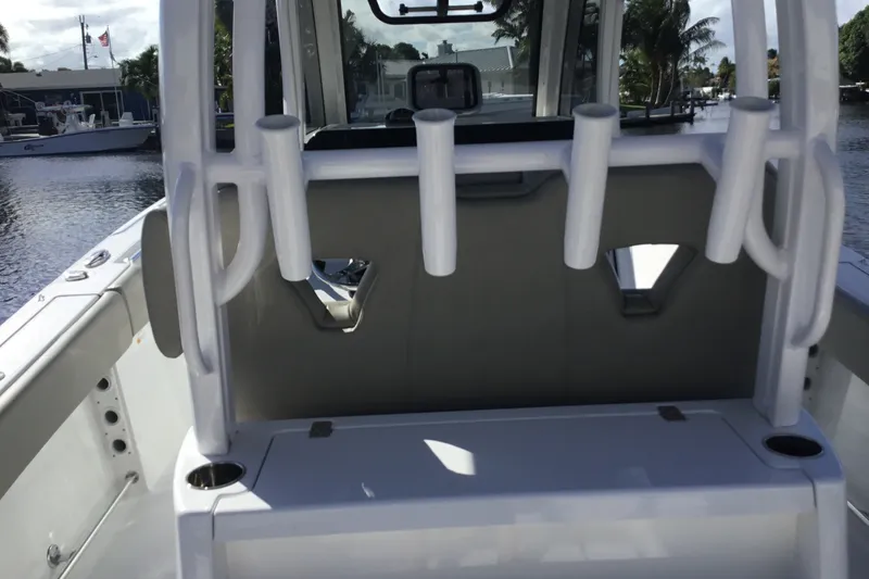 Slide: The Image of 2025 Sportsman Open 322 Center Console boat interior with rod holders and seating. - 57