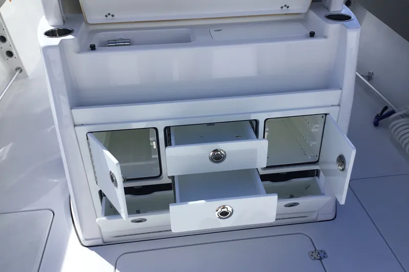 Slide: The Image of 2025 Sportsman Open 322 Center Console storage compartments with open drawers and cabinets. - 62