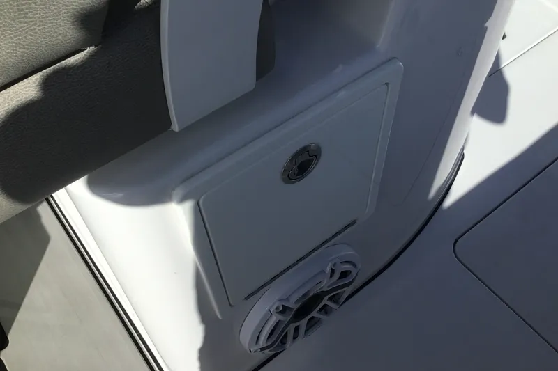 Slide: The Image of 2025 Sportsman Open 322 Center Console boat interior detail with storage compartment and speaker. - 67
