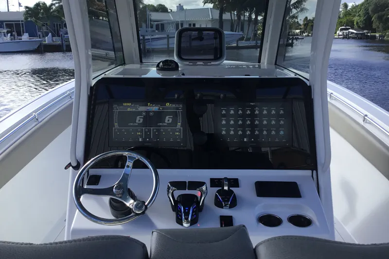 Slide: The Image of 2025 Sportsman Open 322 Center Console boat dashboard with modern controls and navigation screens. - 36