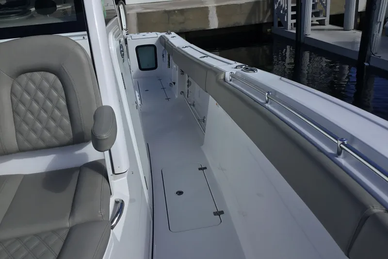 Slide: The Image of 2025 Sportsman Open 322 Center Console boat interior with gray seating and sleek design. - 27
