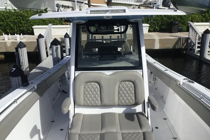Slide: The Image of 2025 Sportsman Open 322 Center Console boat docked, featuring sleek seating and modern design. - 16