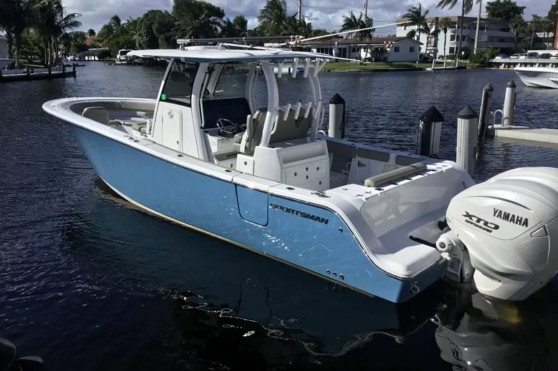Slide: The Image of 2025 Sportsman Open 322 Center Console boat docked, featuring Yamaha XTO outboard engine. - 72