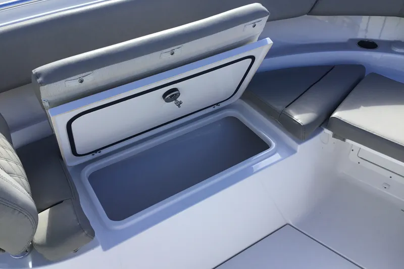 Slide: The Image of 2025 Sportsman Open 322 Center Console boat with open storage compartment and cushioned seating. - 22