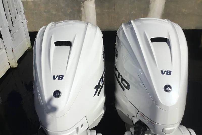 Slide: The Image of Twin V8 outboard engines on a 2025 Sportsman Open 322 Center Console boat. - 64