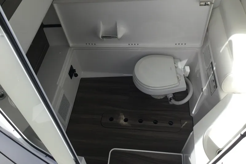 Slide: The Image of 2025 Sportsman Open 322 Center Console boat interior with modern marine toilet. - 28