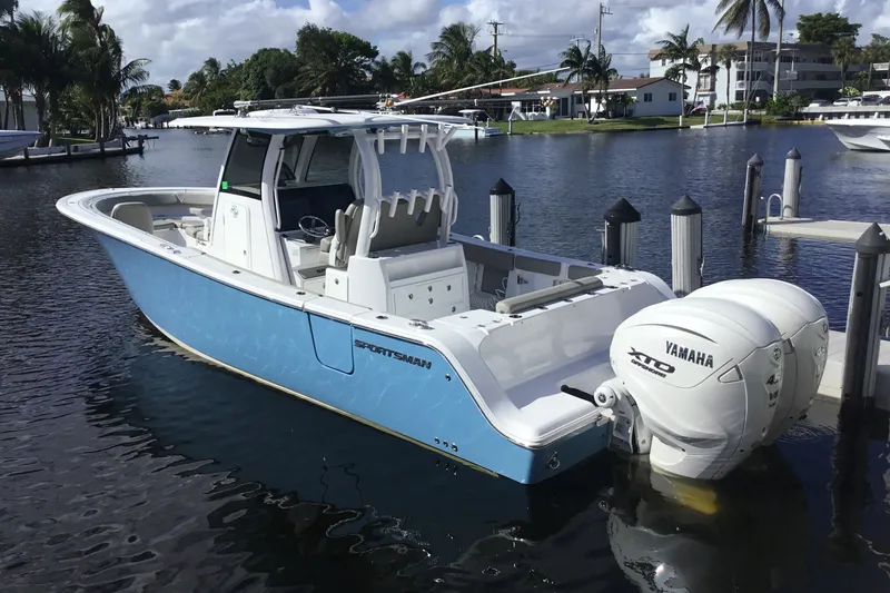 Slide: The Image of 2025 Sportsman Open 322 Center Console boat docked with Yamaha engines. - 14
