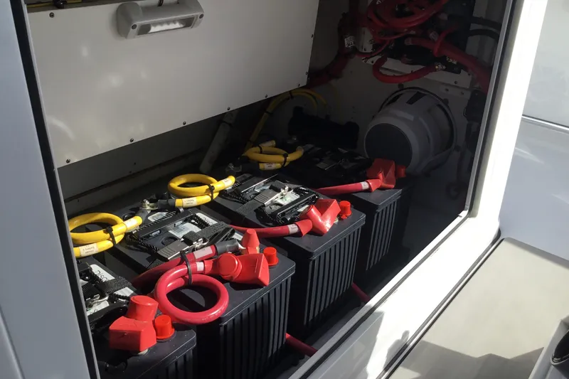 Slide: The Image of Battery compartment of 2025 Sportsman Open 322 Center Console boat with red and yellow cables. - 46