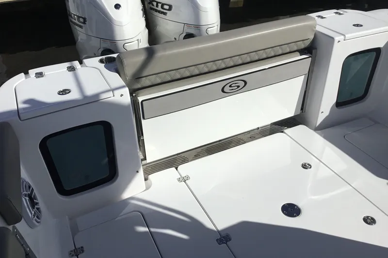 Slide: The Image of 2025 Sportsman Open 322 Center Console boat with dual outboard engines and seating area. - 48