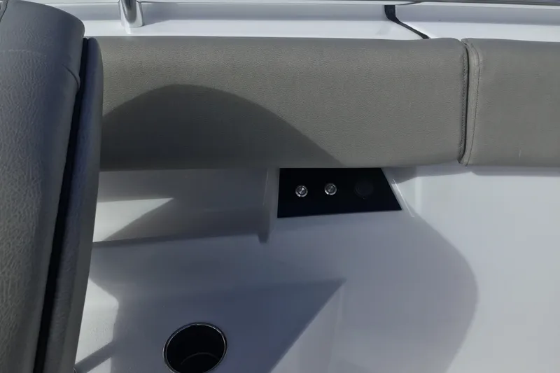 Slide: The Image of 2025 Sportsman Open 322 Center Console interior detail with gray upholstery and control panel. - 24