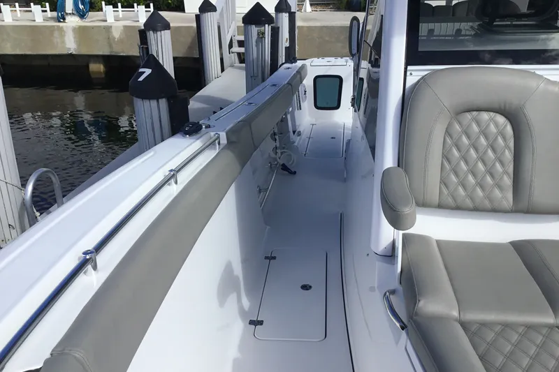 Slide: The Image of 2025 Sportsman Open 322 Center Console boat interior with gray seating and sleek design. - 25