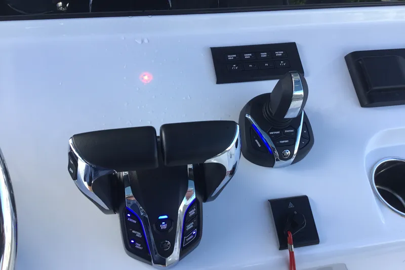 Slide: The Image of Control panel of 2025 Sportsman Open 322 Center Console boat with throttle and joystick. - 40