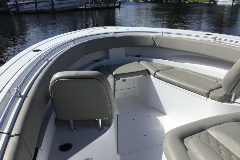 Slide: The Image of 2025 Sportsman Open 322 Center Console boat interior with cushioned seating and sleek design. - 19
