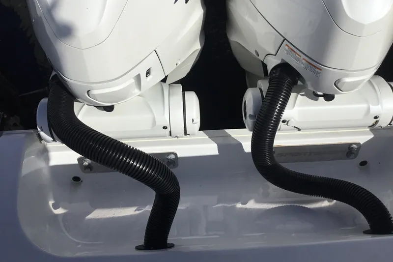 Slide: The Image of Twin outboard motors on a 2025 Sportsman Open 322 Center Console boat. - 63