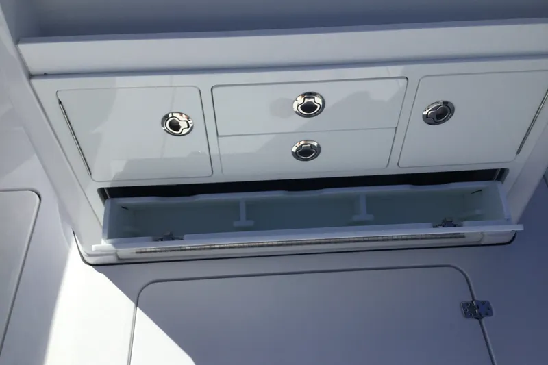 Slide: The Image of 2025 Sportsman Open 322 Center Console storage compartments with open drawer. - 61