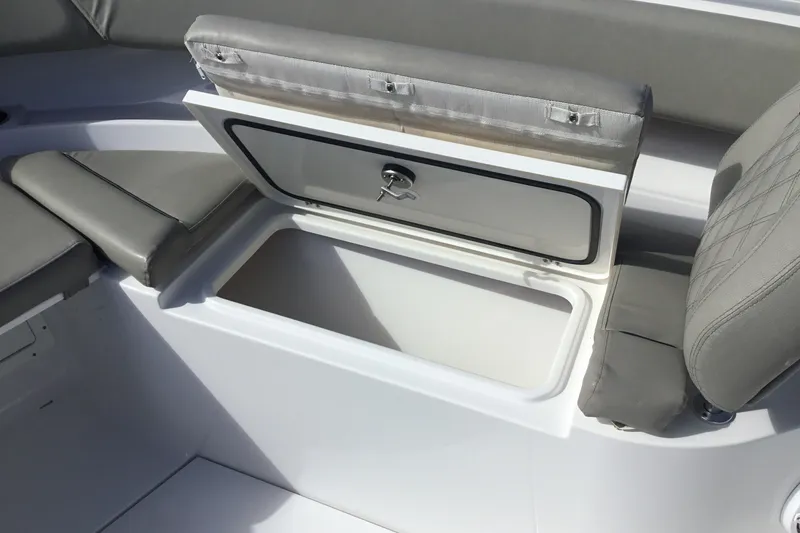 Slide: The Image of 2025 Sportsman Open 322 Center Console boat with open storage compartment and cushioned seating. - 21