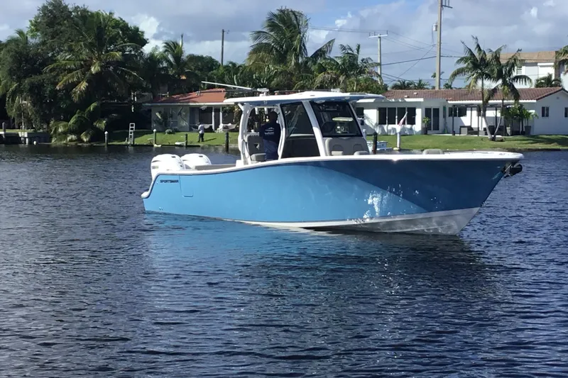 Slide: The Image of 2025 Sportsman Open 322 Center Console boat on a calm waterway. - 6