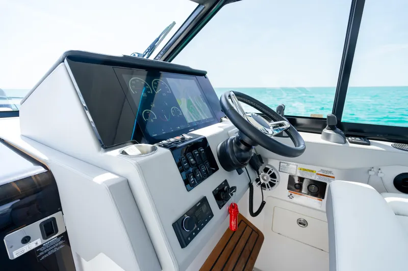 Slide: The Image of 2022 Regal 36 Grande Coupe helm with modern controls and ocean view. - 64
