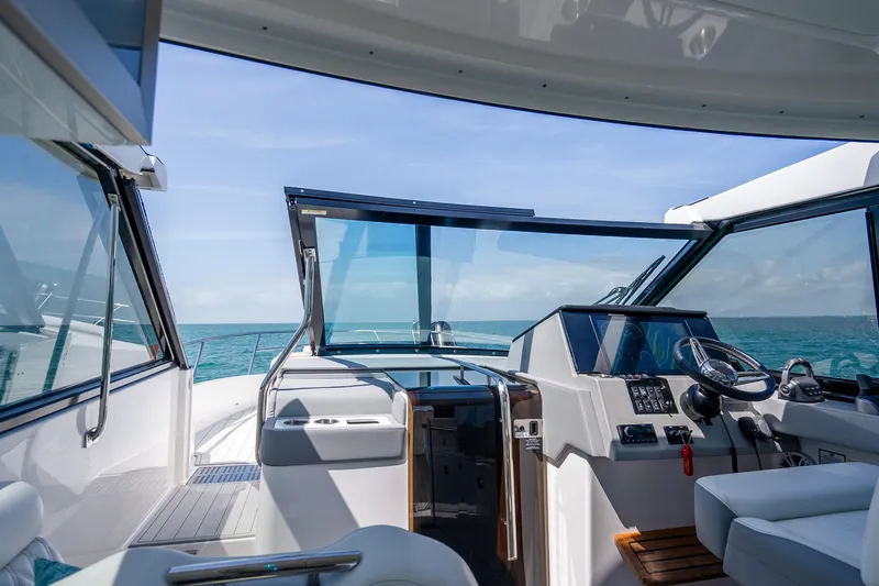 Slide: The Image of 2022 Regal 36 Grande Coupe yacht cockpit with ocean view. - 20