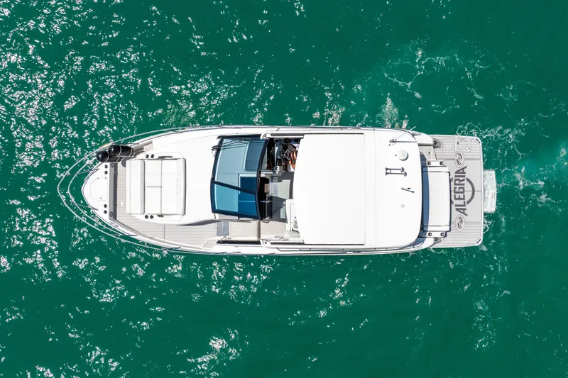 Slide: The Image of Overhead view of 2022 Regal 36 Grande Coupe yacht on turquoise water. - 2