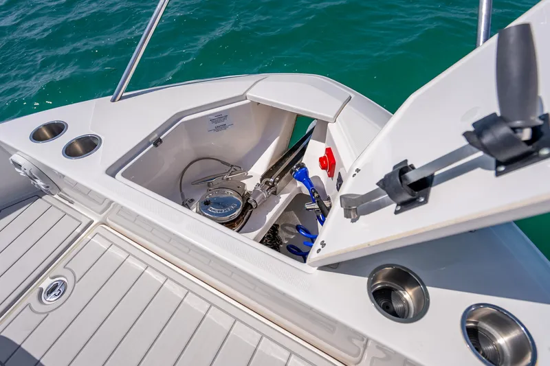 Slide: The Image of Open anchor locker on 2022 Regal 36 Grande Coupe boat, showing equipment and storage. - 70