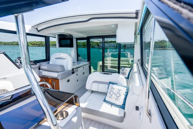 Slide: The Image of Luxurious interior of 2022 Regal 36 Grande Coupe yacht with plush seating and scenic water view. - 19