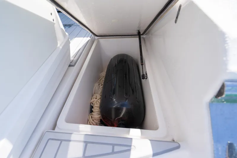 Slide: The Image of Storage compartment on 2022 Regal 36 Grande Coupe boat with fender and rope. - 59