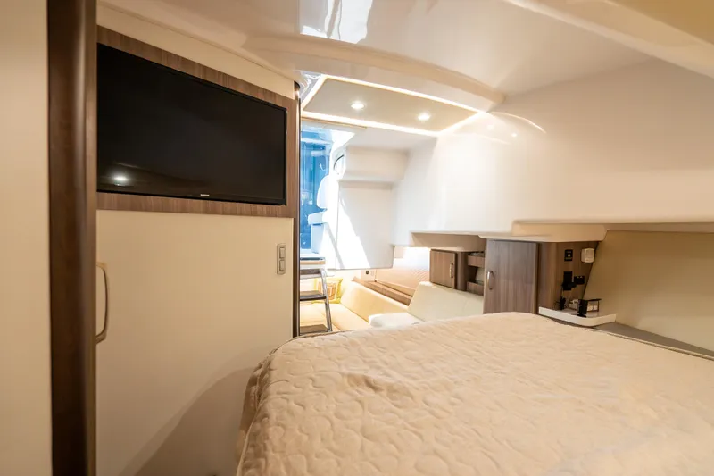Slide: The Image of Interior of 2022 Regal 36 Grande Coupe yacht with bed, TV, and modern furnishings. - 56