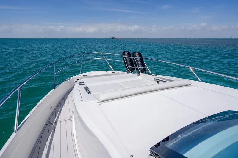 Slide: The Image of 2022 Regal 36 Grande Coupe yacht cruising on open blue sea. - 14