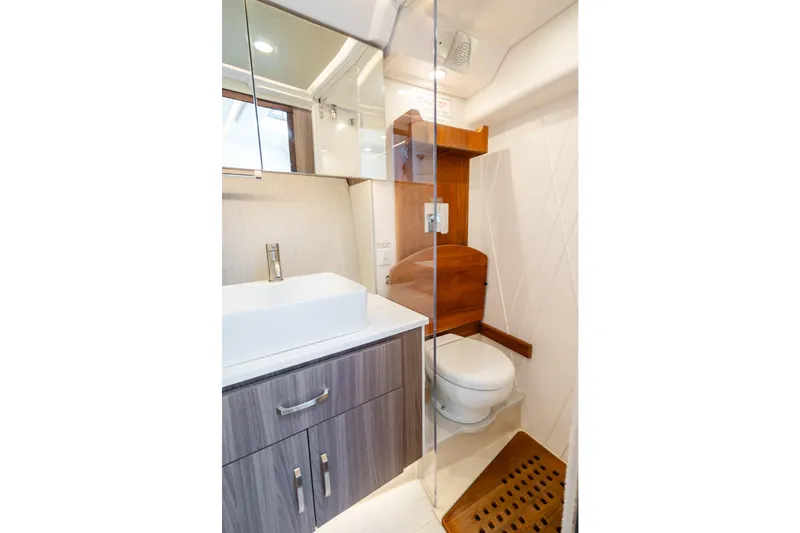 Slide: The Image of Modern bathroom in 2022 Regal 36 Grande Coupe yacht, featuring sleek design and wood accents. - 46