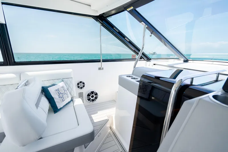 Slide: The Image of Interior of 2022 Regal 36 Grande Coupe yacht with ocean view and modern seating. - 32