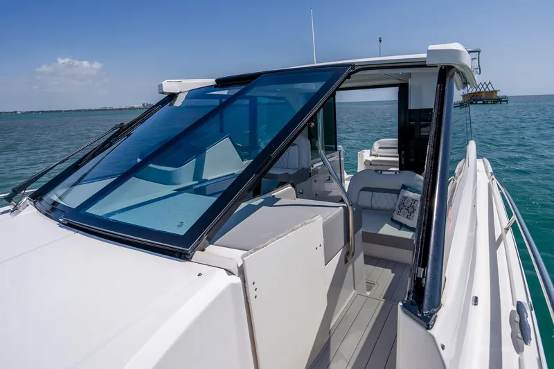 Slide: The Image of 2022 Regal 36 Grande Coupe yacht on open water, showcasing sleek design and luxurious interior. - 17