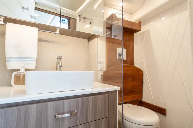Slide: The Image of Luxurious bathroom in 2022 Regal 36 Grande Coupe yacht, featuring modern sink and toilet. - 58