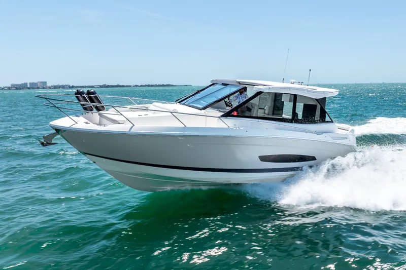 Slide: The Image of 2022 Regal 36 Grande Coupe cruising on open water, showcasing sleek design and performance. - 12
