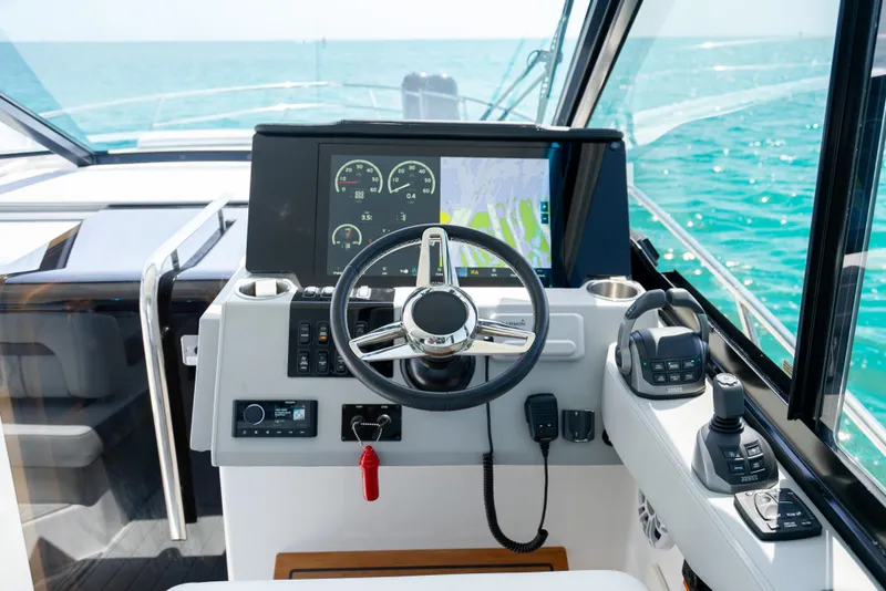 Slide: The Image of Cockpit of 2022 Regal 36 Grande Coupe with steering wheel and navigation display. - 36