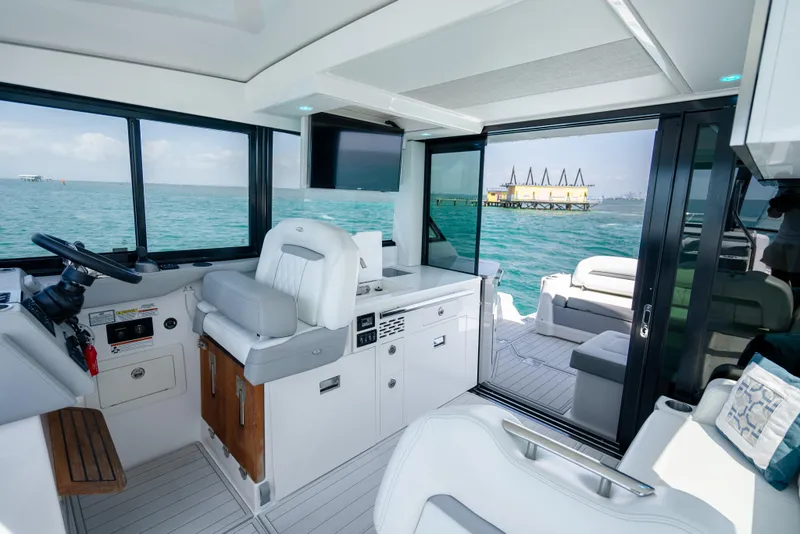 Slide: The Image of Interior of 2022 Regal 36 Grande Coupe yacht with ocean view through windows. - 30
