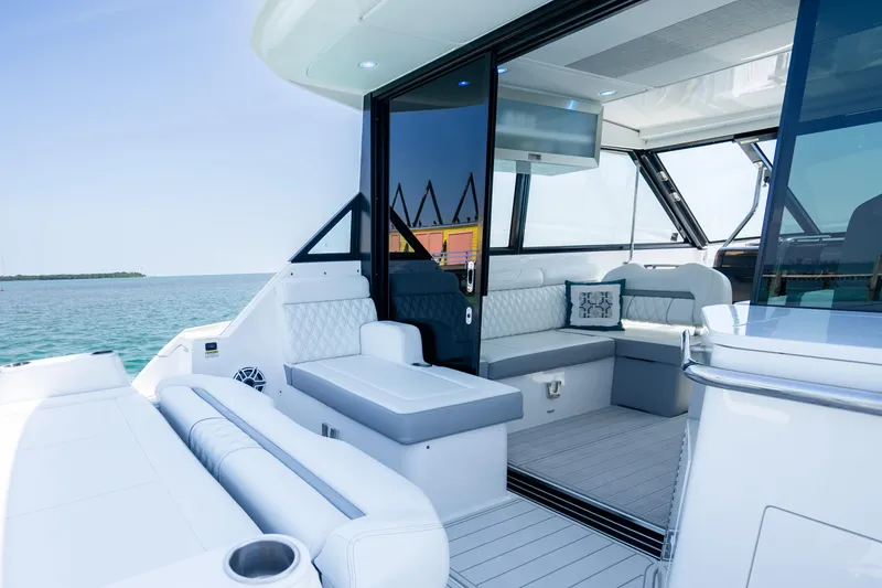 Slide: The Image of Luxurious interior of 2022 Regal 36 Grande Coupe yacht with elegant seating and ocean view. - 22