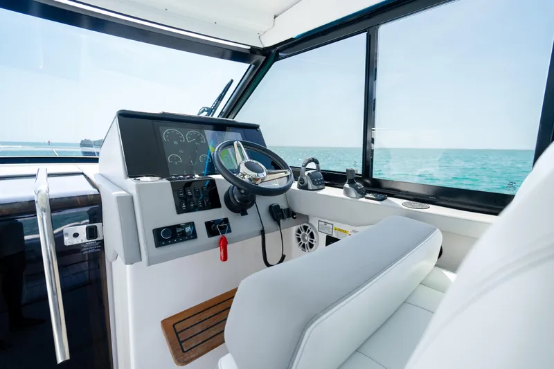 Slide: The Image of Helm of 2022 Regal 36 Grande Coupe yacht with ocean view. - 34