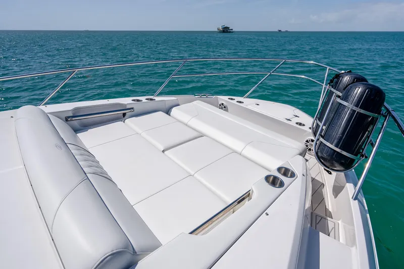 Slide: The Image of Luxurious 2022 Regal 36 Grande Coupe yacht with spacious sunbathing deck on open sea. - 15