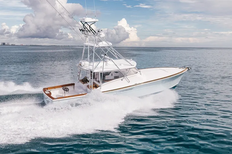 Slide: The Image of 2025 Release Boatworks 46 Express cruising on open water under a cloudy sky. - 22
