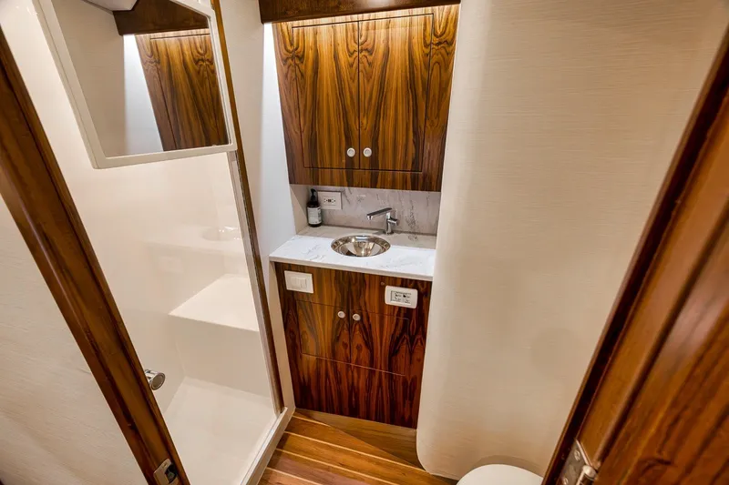 Slide: The Image of Luxurious 2025 Release Boatworks 46 Express bathroom with elegant wood cabinetry and modern fixtures. - 68