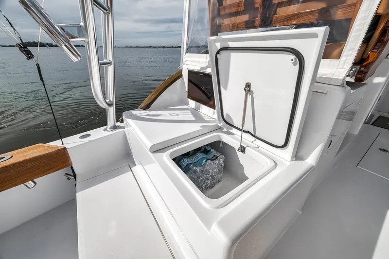 Slide: The Image of 2025 Release Boatworks 46 Express deck with open storage compartment by the water. - 52